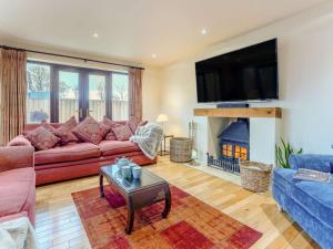 a living room with a couch and a fire place at 4 Bed in Ashford oc-86647 in Ashford