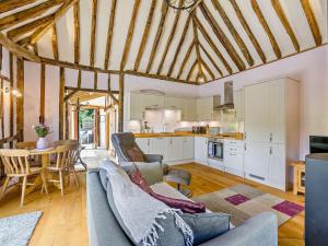 a living room with a couch and a table at 1 Bed in Dunmow oc-51222 in Thaxted