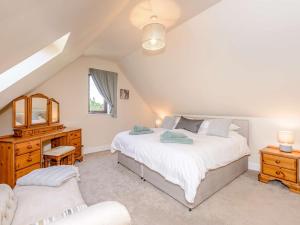 a bedroom with two beds and a desk and a chair at 4 Bed in Ashford oc-86647 in Ashford