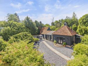 an exterior view of a house in the woods at 1 Bed in Dunmow oc-51222 in Thaxted