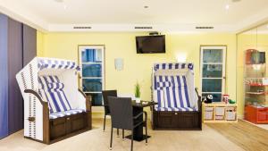 a living room with two chairs and a table at Hapimag Resort Dünenblick in Westerland