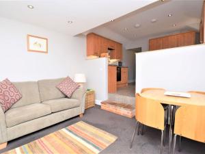 a living room with a couch and a table at 1 Bed in Holt oc-ncc04 in Cley next the Sea