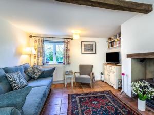 a living room with a blue couch and a chair at 2 Bed in Syderstone oc-kt146 in Syderstone
