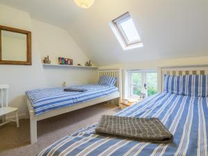 a bedroom with two beds and a window at 2 Bed in Syderstone oc-kt146 in Syderstone