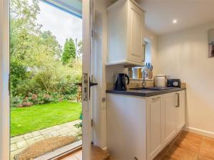 a kitchen with a view of a garden through a door at 2 Bed in Syderstone oc-kt146 in Syderstone