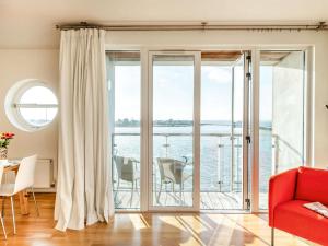 a living room with sliding glass doors with a view of the water at 2 Bed in Colchester oc-90382 in Saint Osyth +15 photos