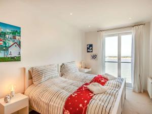 a bedroom with a bed and a large window at 2 Bed in Colchester oc-90382 in Saint Osyth