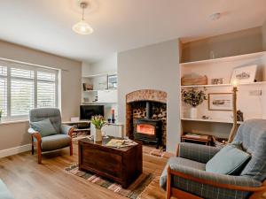 a living room with a couch and a fireplace at 2 Bed in Melton Constable oc-91371 in Briston