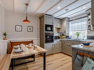 a kitchen with a wooden table and a dining room at 2 Bed in Melton Constable oc-91371 in Briston