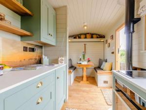 a kitchen with green cabinets and a dining room at 1 Bed in Canterbury oc-88795 in Chillenden +9 photos
