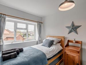 a bedroom with a bed and a large window at 2 Bed in Melton Constable oc-91371 in Briston