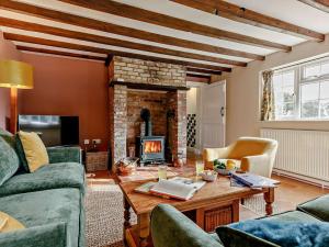 a living room with a fireplace and a table at 3 Bed in Market Rasen oc-93253 in Ranby