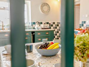 a bowl of fruit on a table in a kitchen at 3 Bed in Market Rasen oc-93253 in Ranby +21 photos