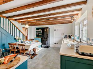 a kitchen with a table and a dining room at 3 Bed in Market Rasen oc-93253 in Ranby