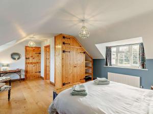 a bedroom with a large white bed and a desk at 3 Bed in Market Rasen oc-93253 in Ranby