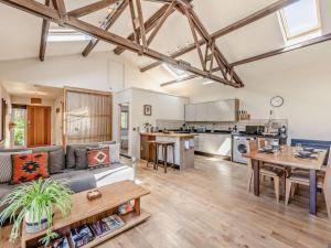 a living room with a couch and a table at 1 Bed in Chichester oc-77402 in Eastergate +15 photos