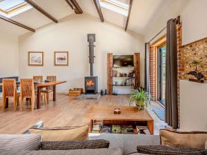 a living room with a table and a fireplace at 1 Bed in Chichester oc-77402 in Eastergate