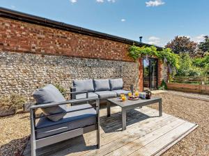 a patio with two chairs and a table at 1 Bed in Chichester oc-77402 in Eastergate