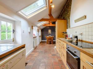 a large kitchen with a skylight in the ceiling at 2 Bed in Field Dalling oc-kt007 in Saxlingham