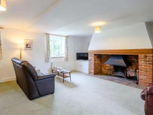 a living room with a couch and a fireplace at 2 Bed in Field Dalling oc-kt007 in Saxlingham