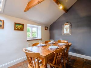 a dining room with a wooden table and chairs at 2 Bed in Field Dalling oc-kt007 in Saxlingham +9 photos