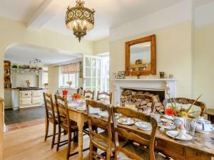 a dining room with a table and chairs and a fireplace at 5 Bed in Dereham oc-89542 in Swanton Morley