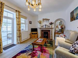 a living room with a couch and a fireplace at 3 Bed in Bognor Regis oc-83115 in Bognor Regis