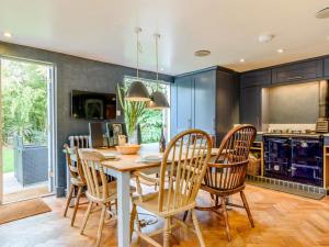 a kitchen with a wooden table and chairs at 3 Bed in Faversham oc-78880 in Faversham