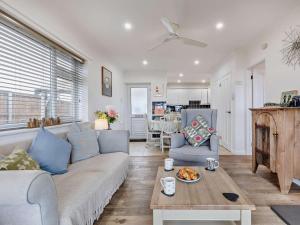 a living room with a couch and chairs and a table at 2 Bed in Norwich oc-75391 in Bacton +13 photos