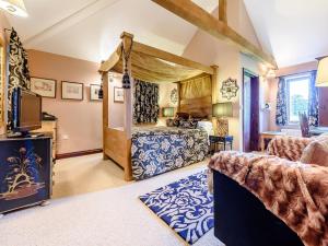 a bedroom with a canopy bed and a living room at 2 Bed in Bedford oc-79558 in Wyboston