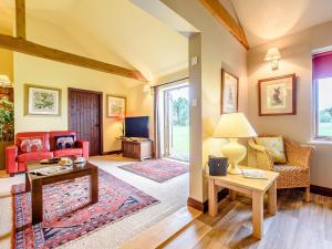 a living room with a couch and a table at 2 Bed in Bedford oc-79558 in Wyboston