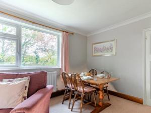 a dining room with a table and a couch at 2 Bed in Dereham oc-shrn8 in East Dereham +8 photos