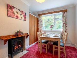 a dining room with a table and a fireplace at 2 Bed in Dereham oc-shrn8 in East Dereham
