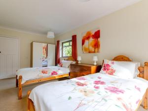 a bedroom with two beds and a mirror at 2 Bed in Dereham oc-shrn8 in East Dereham
