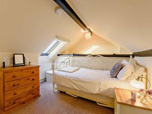 a bedroom with a bed and a dresser and a window at 2 Bed in Arundel oc-89671 in Arundel