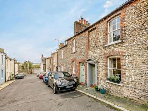 a street with cars parked in front of a brick building at 2 Bed in Arundel oc-89671 in Arundel
