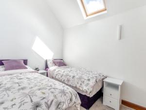 a bedroom with two beds and a window at 2 Bed in Lincoln oc-93058 in Saxilby