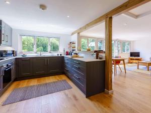 a kitchen with gray cabinets and a dining room at 2 Bed in Uckfield oc-80504 in Framfield