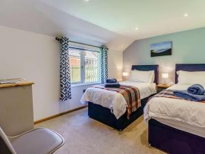 a bedroom with two beds and a window at 2 Bed in Uckfield oc-80504 in Framfield +13 photos