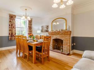 a dining room with a table and a fireplace at 5 Bed in Wisbech oc-90134 in Wisbech