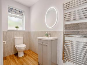 a bathroom with a toilet and a sink and a mirror at 2 Bed in Mablethorpe oc-93143 in Trusthorpe +18 photos