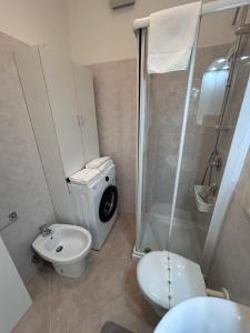 a bathroom with a shower and a toilet and a sink at Casa Memi in Chioggia