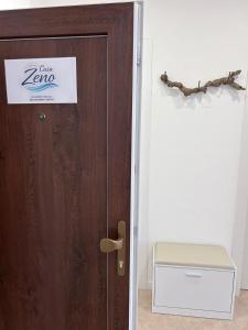 a door with a sign on it in a room at Casa Memi in Chioggia +26 photos