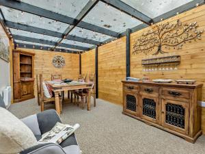 a living room with a table and a wooden wall at 3 Bed in Bognor Regis oc-93447 in Bognor Regis