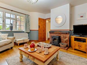 a living room with a table and a fireplace at 3 Bed in Norwich oc-85528 in Thurgarton