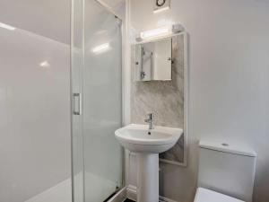a white bathroom with a sink and a shower at 3 Bed in Bognor Regis oc-93447 in Bognor Regis +9 photos