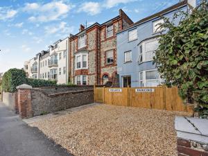 an exterior view of a house with a wooden fence at 3 Bed in Bognor Regis oc-93447 in Bognor Regis