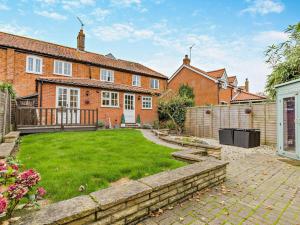 an exterior view of a brick house with a yard at 3 Bed in Norwich oc-85528 in Thurgarton