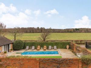 a house with a swimming pool and a field at 1 Bed in Horsham oc-86961 in Rudgwick