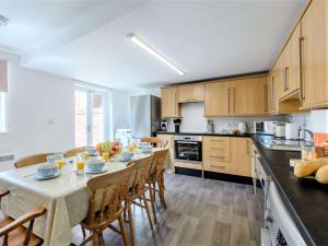 a kitchen with a table and chairs in a kitchen at 4 Bed in Skegness oc-81343 in Wainfleet All Saints
